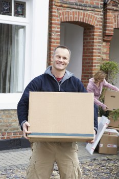 Moving house in London with packed boxes and removal van
