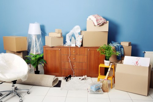 Furniture removals team handling a sofa in a London property