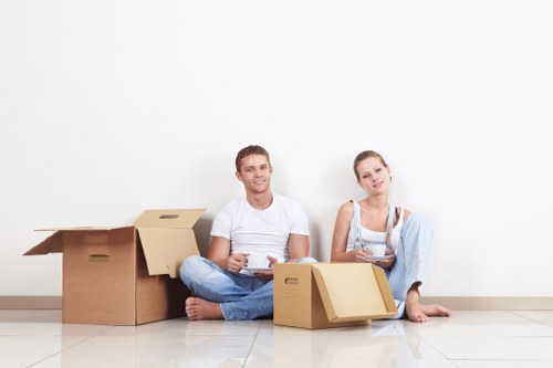 Professional movers packing household items for a London move