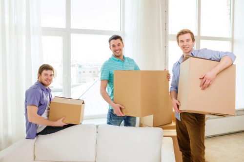 Family loading furniture into a hired removal truck